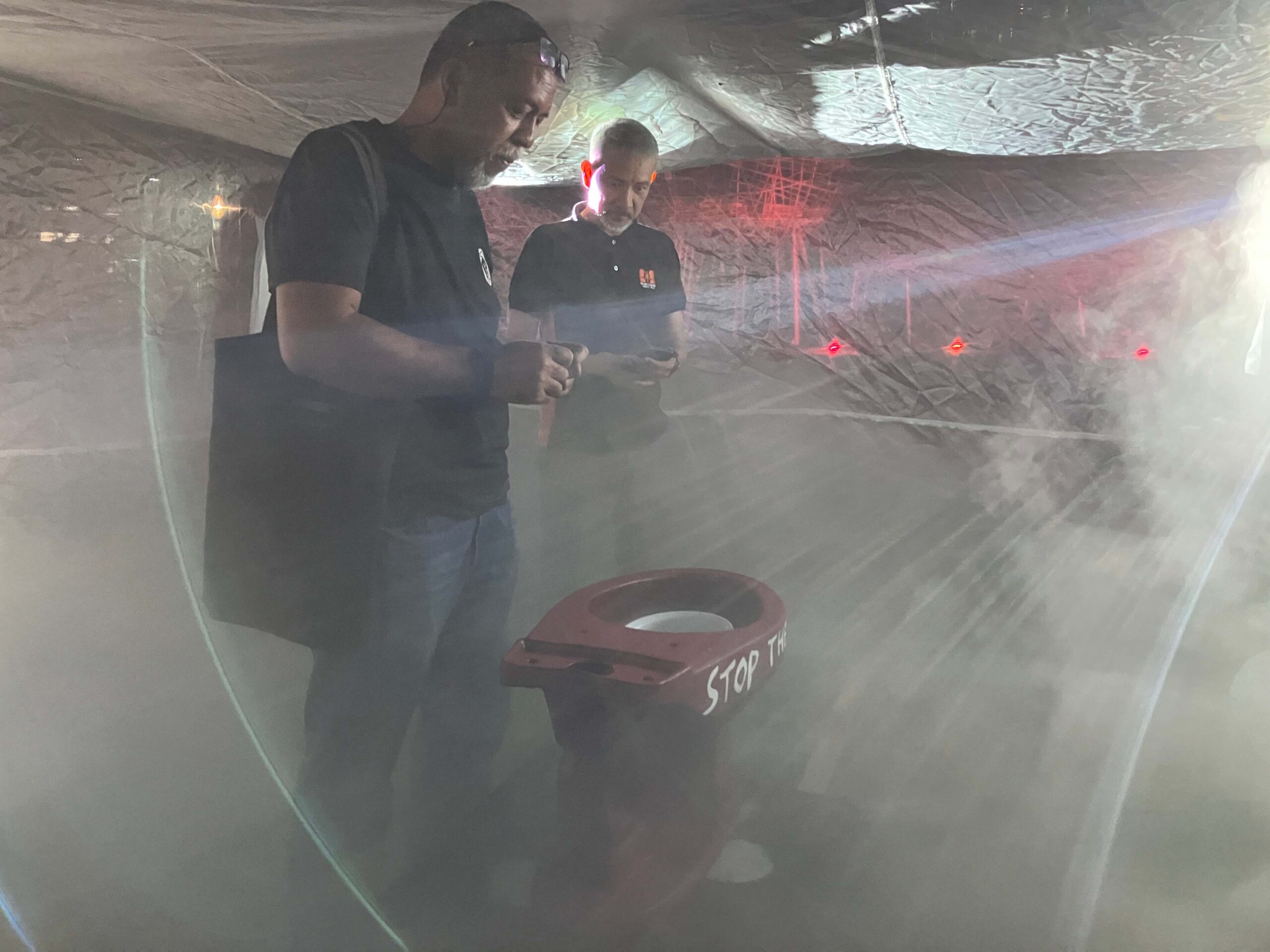 Filmmakers Larry Manda and Ricky Orellana making a wish to the red toilet bowl